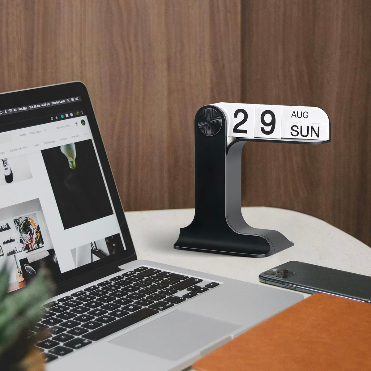 Desktop Flipping Calendar - Modern Black Desk Organizer shown in natural light on a wooden table