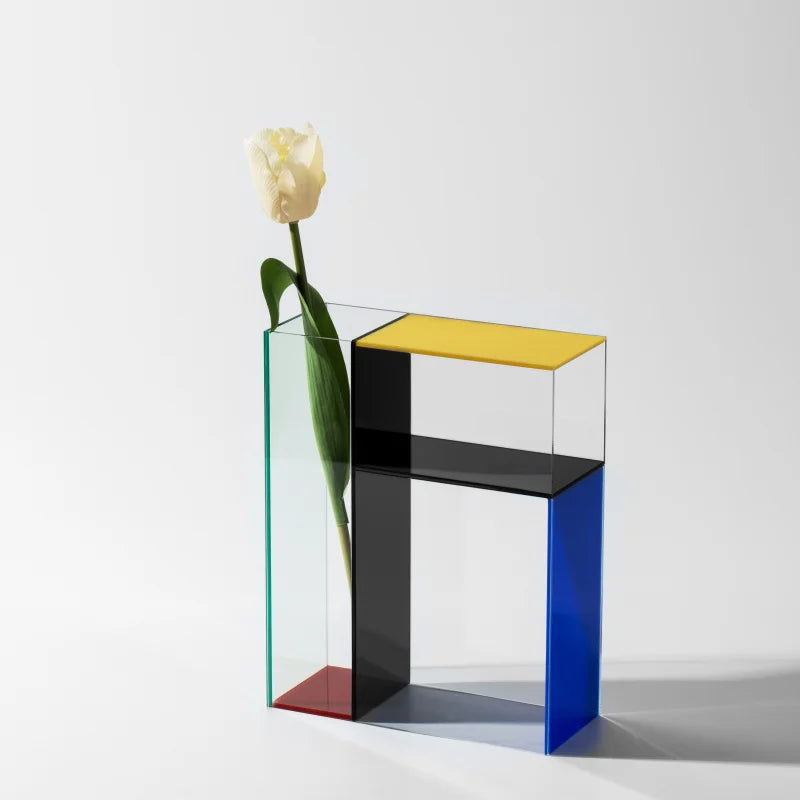 Color block glass vase with single tulip stem, front view