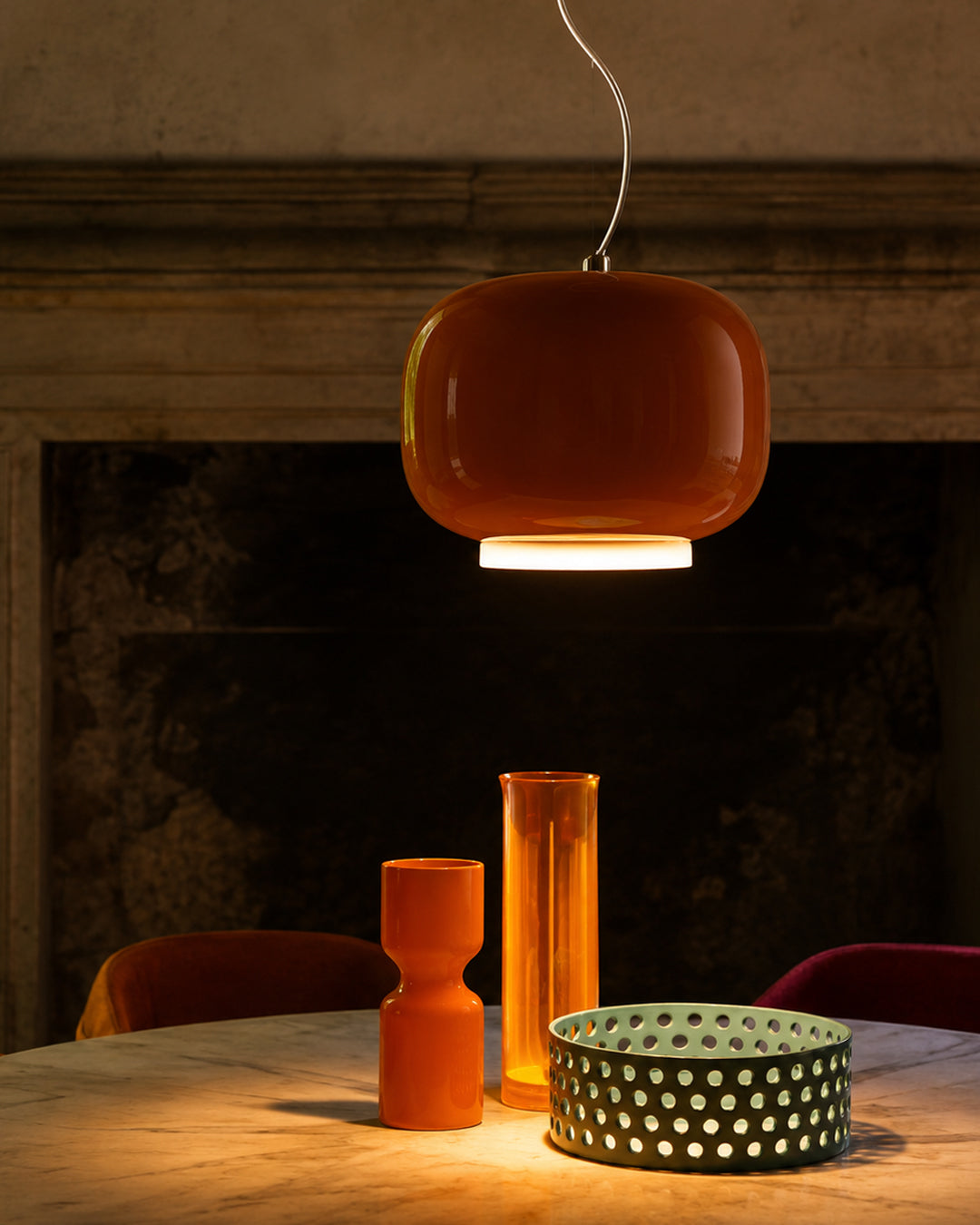 Glass stone pendant light illuminated, showing warm glow