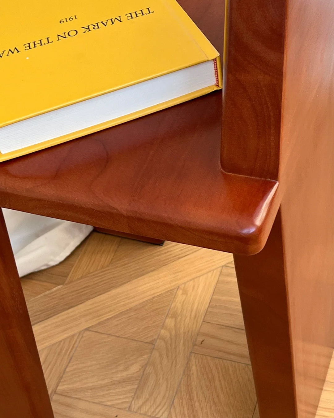 solid wood accent chair shown beside a desk or vanity
