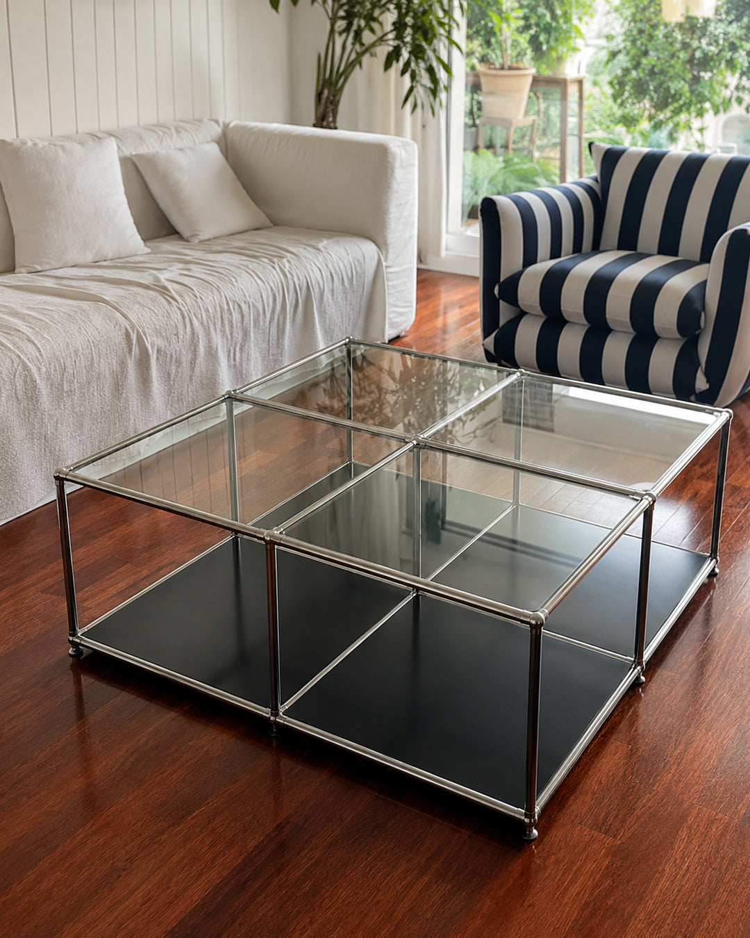 Glass cube table paired with a sofa in a lounge setting