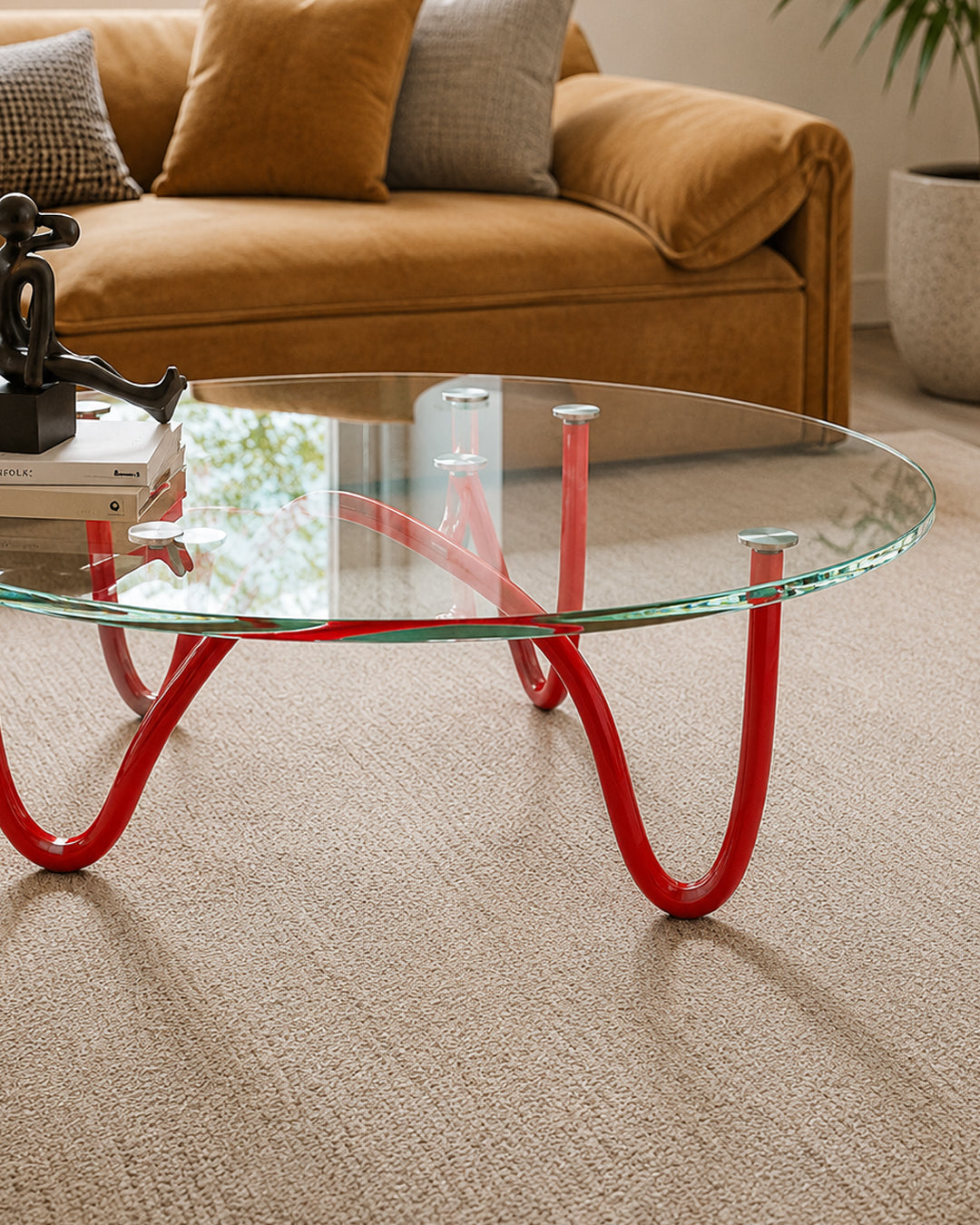 Close-up of looped metal pipe base on glass coffee table