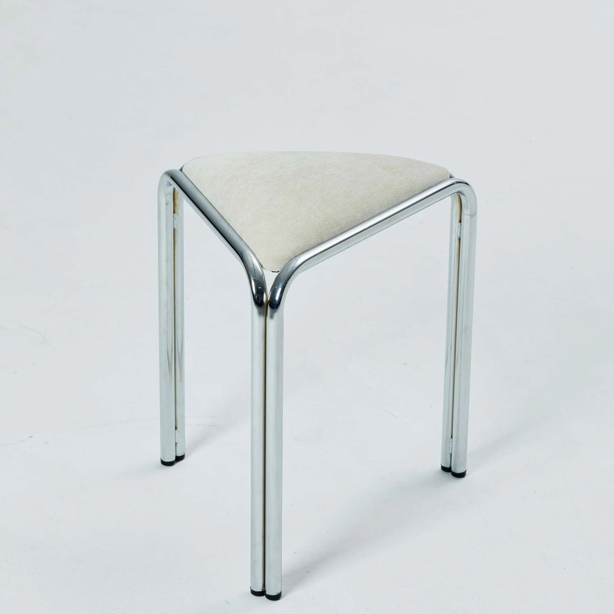 White velvet triangle stacking stool on chrome tube legs, studio shot