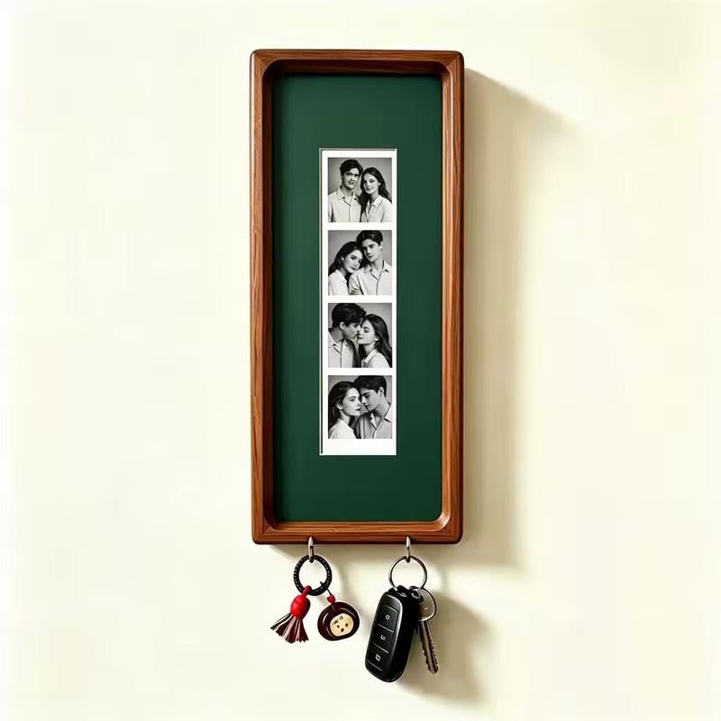 Dark green wood photo strip frame with key hooks, studio shot