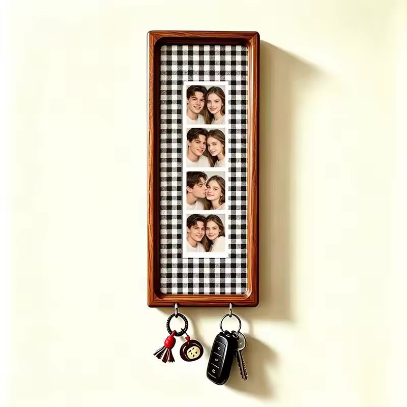 Black and white check wood photo strip frame with key hooks, studio shot