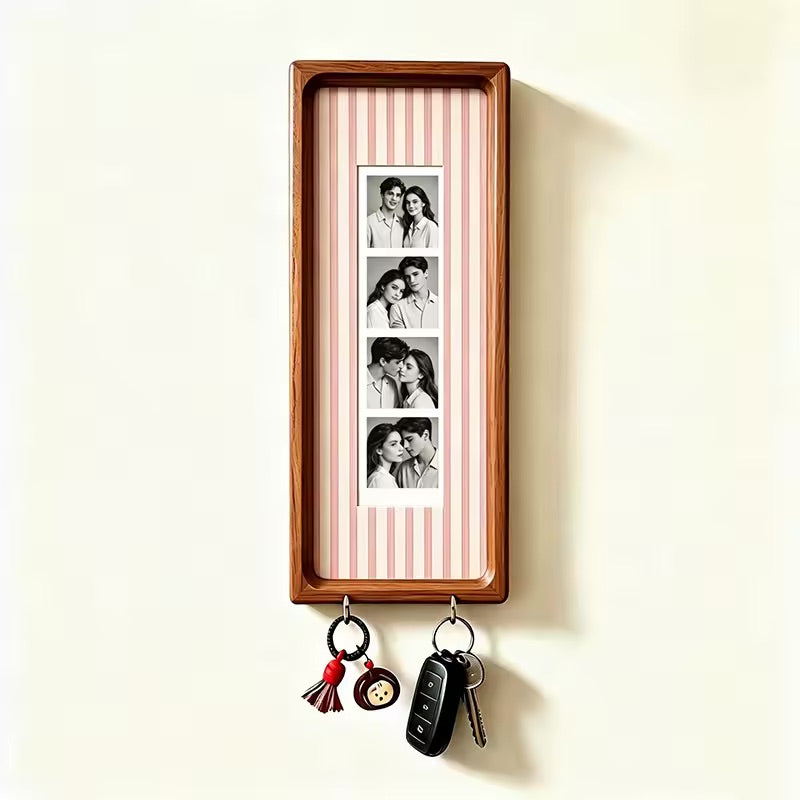 Pink pinstripe wood photo strip frame with key hooks, studio shot