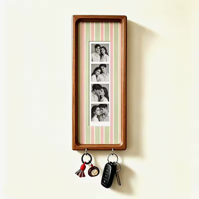Pastel pink and green stripe wood photo strip frame with key hooks, studio shot