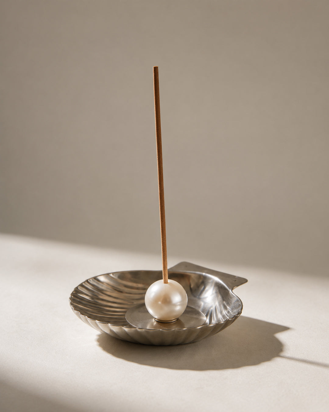 scallop incense holder closeup detail shot showing polished steel and pearl finish
