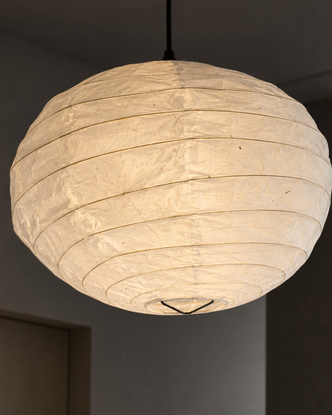 Rice paper pendant lamp styled in a bedroom setting