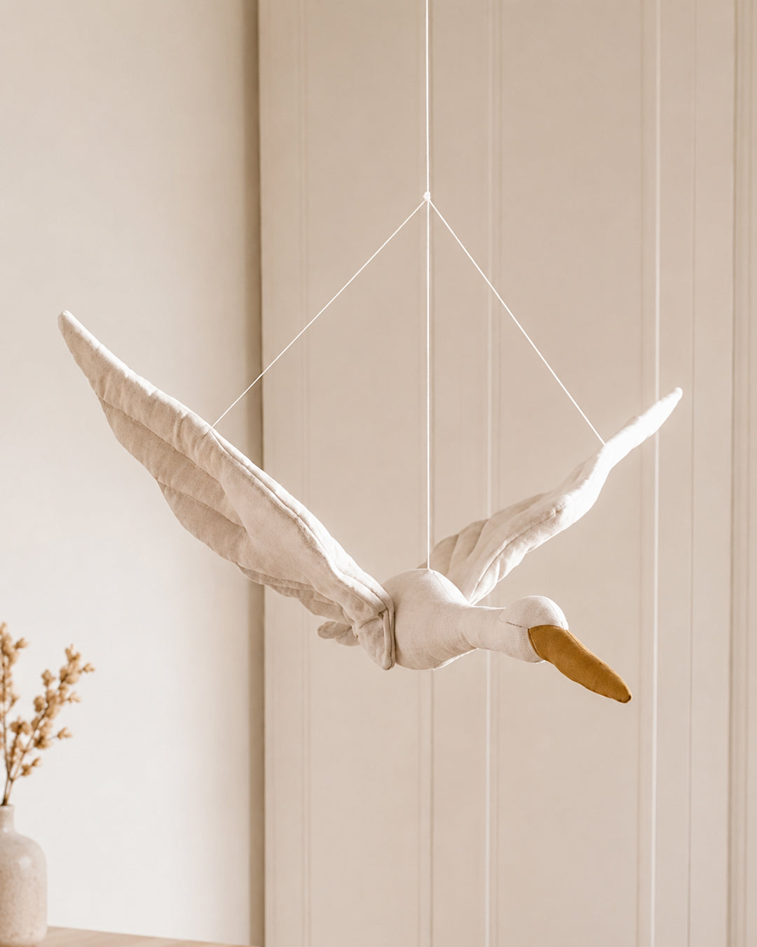 Stork mobile hanging in a nursery ceiling setting