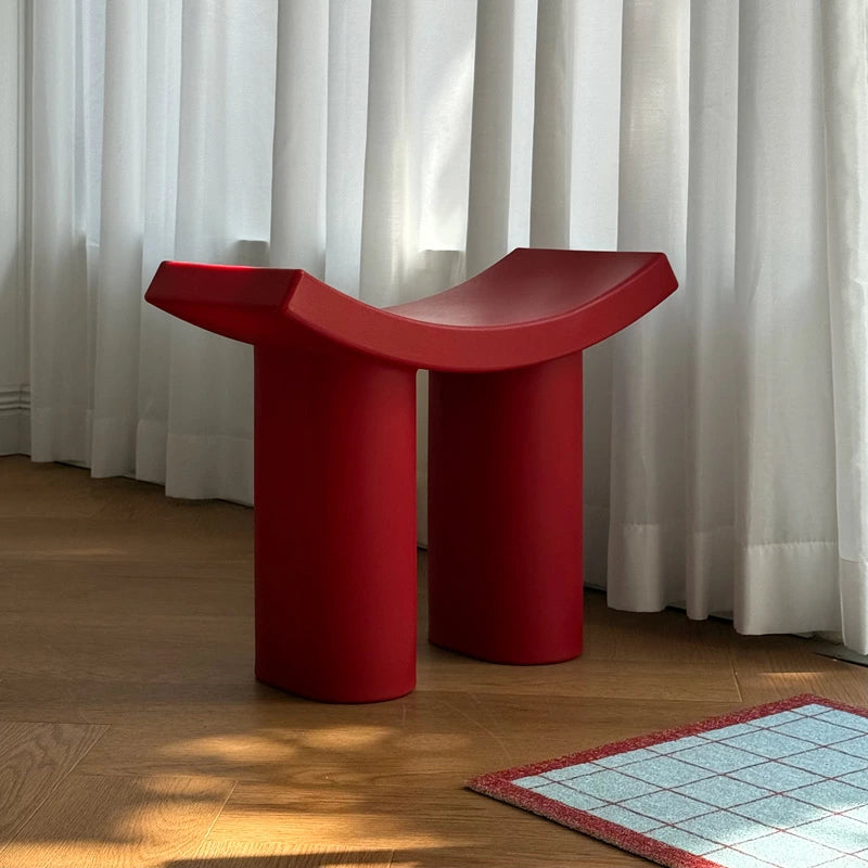 modrn color accent abs stool accent piece styled on a shelf or console table