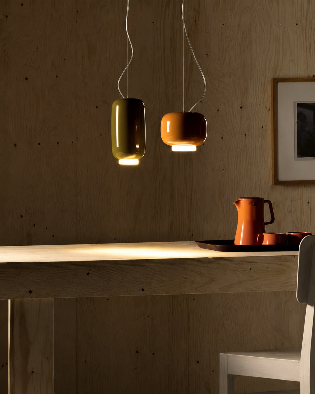 Glass stone pendant light hung over a dining table