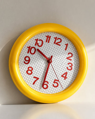 grid wall clock face closeup showing hour markers and hands