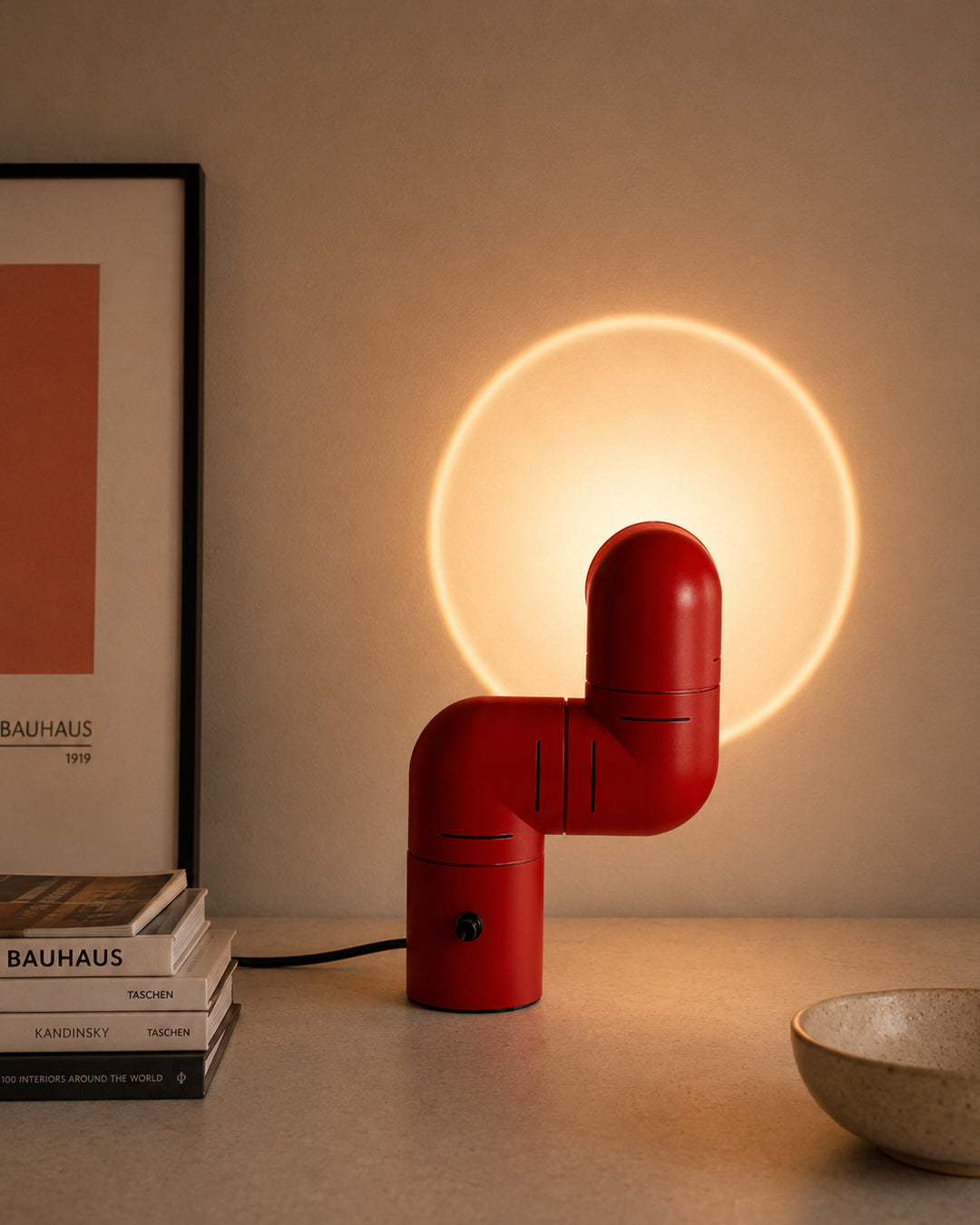 Articulating pipe lamp projecting circular light halo on wall