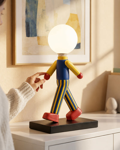 Resin figure table lamp styled on a nightstand