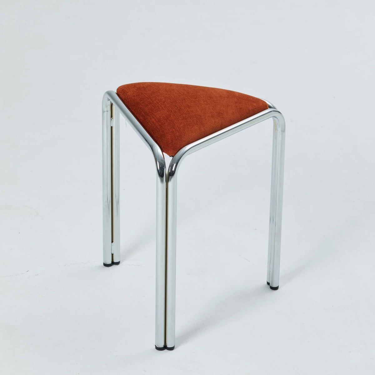 Orange velvet triangle stacking stool on chrome tube legs, studio shot