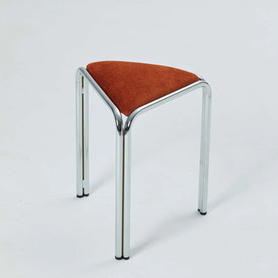 Orange velvet triangle stacking stool on chrome tube legs, studio shot