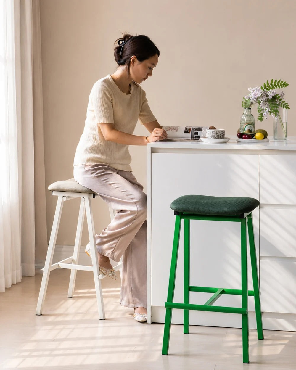 saddle seat metal bar stool back view showing cushioned seat profile