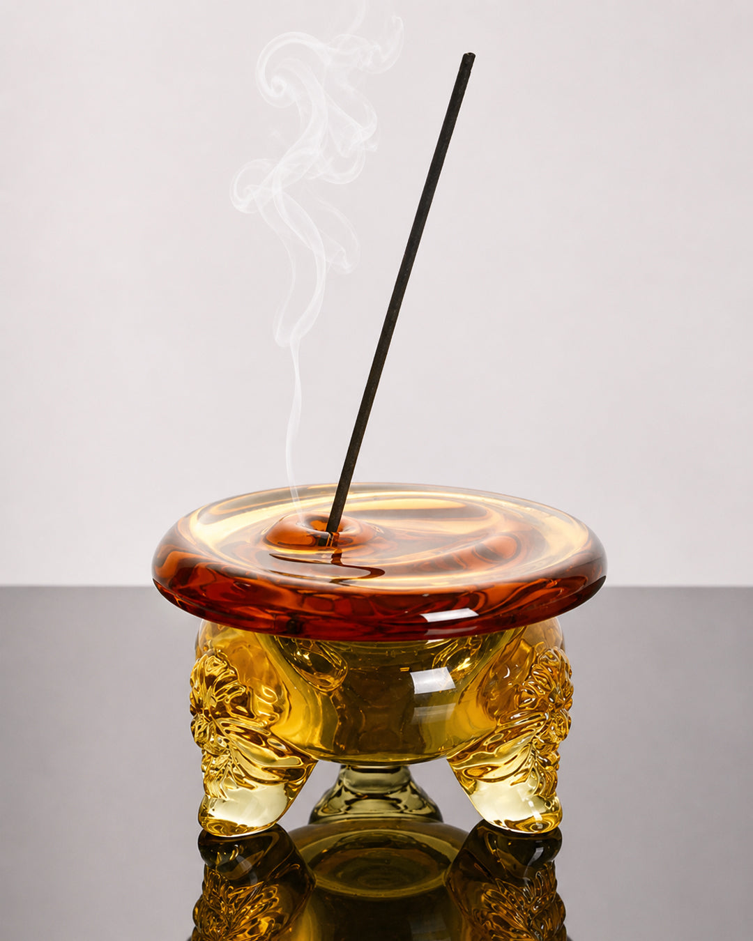 Amber glass incense holder styled on a shelf