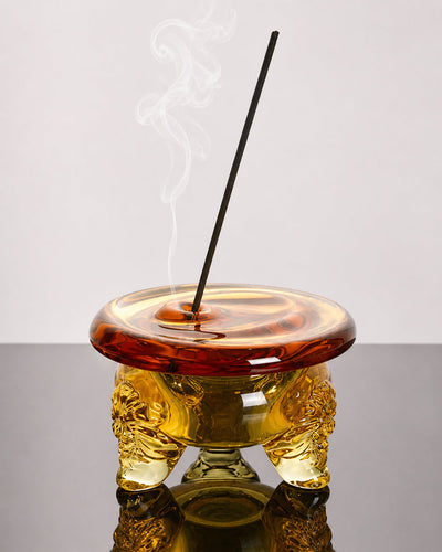 Amber glass incense holder styled on a shelf