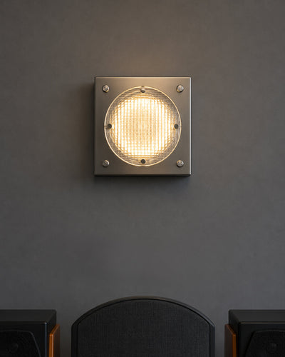 stainless steel wall sconce closeup detail shot showing acrylic grid lens texture