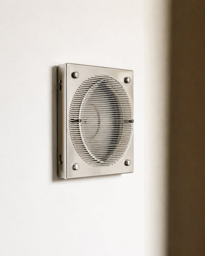 bauhaus wall lamp shown illuminated on a bedroom headboard wall