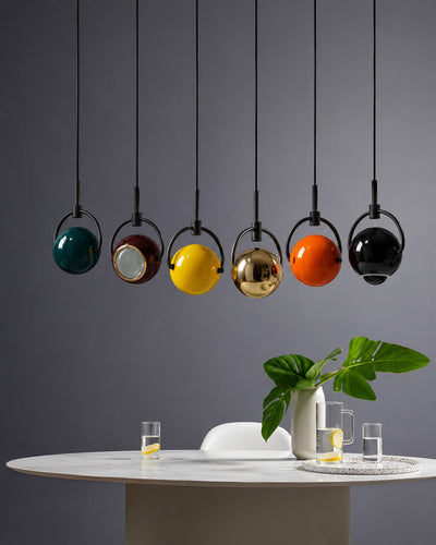 mini pendant light shown grouped in a cluster over a kitchen island