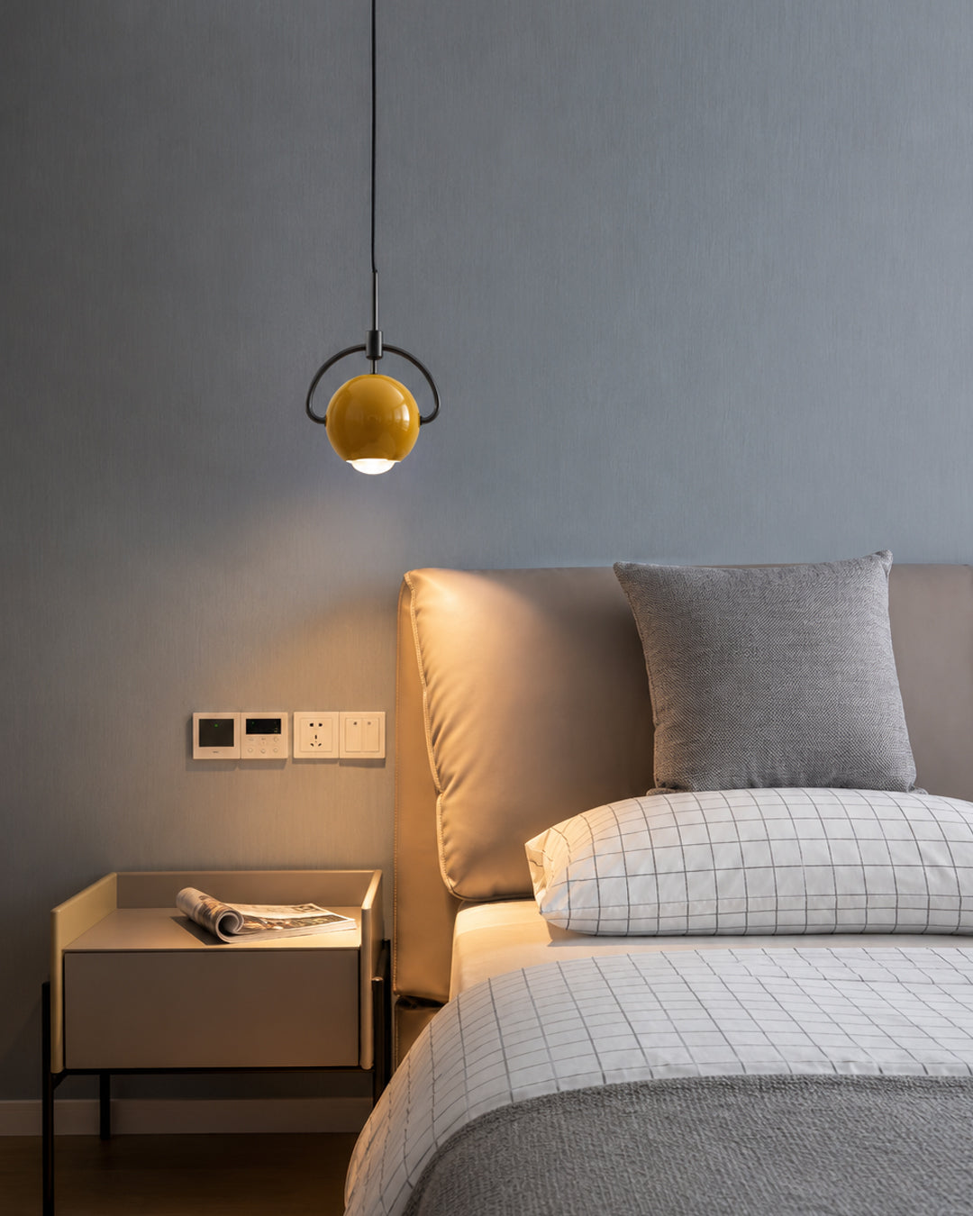 mini orb pendant light shown illuminated with a warm white glow