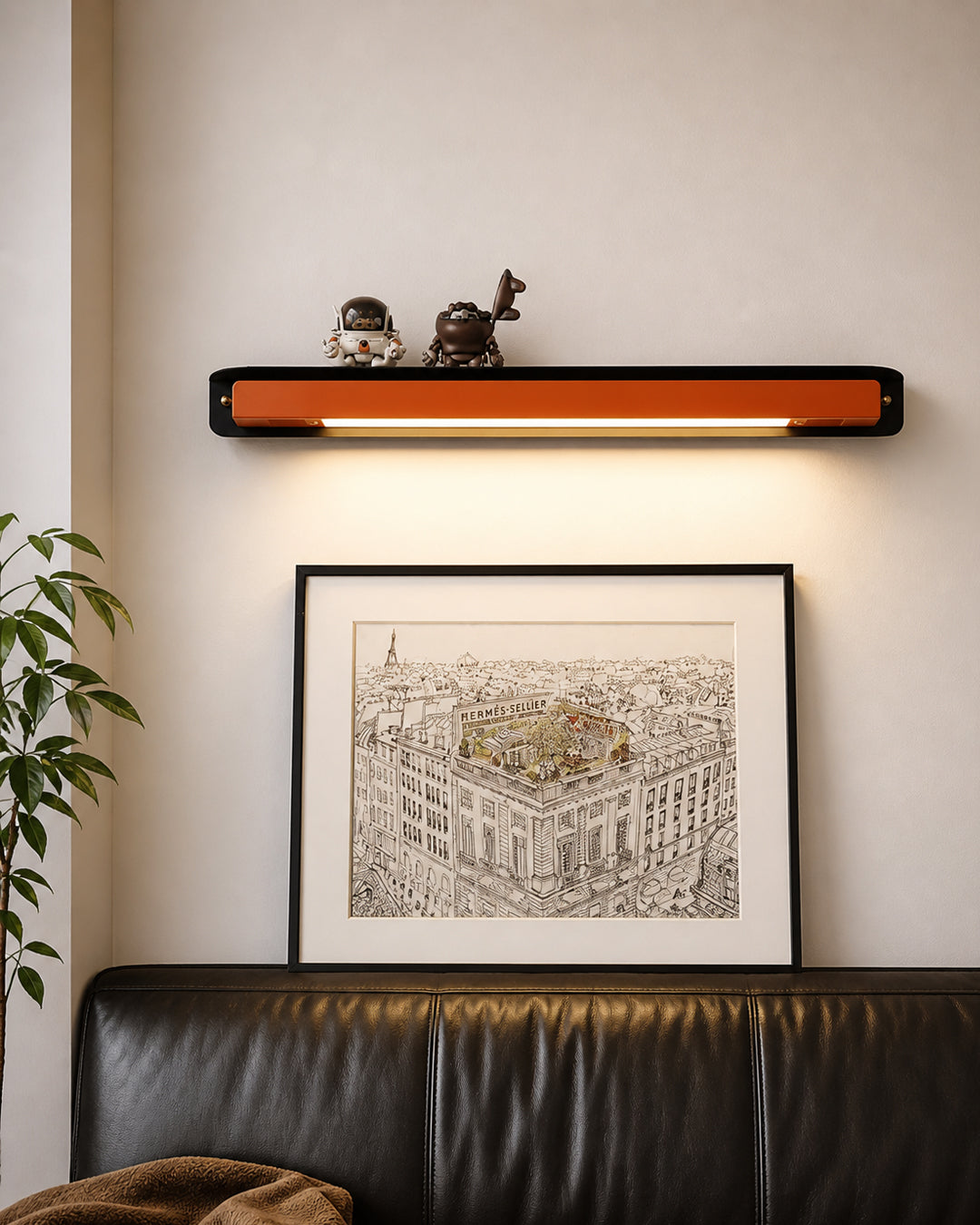 Wall lamp styled with objects displayed on the shelf ledge