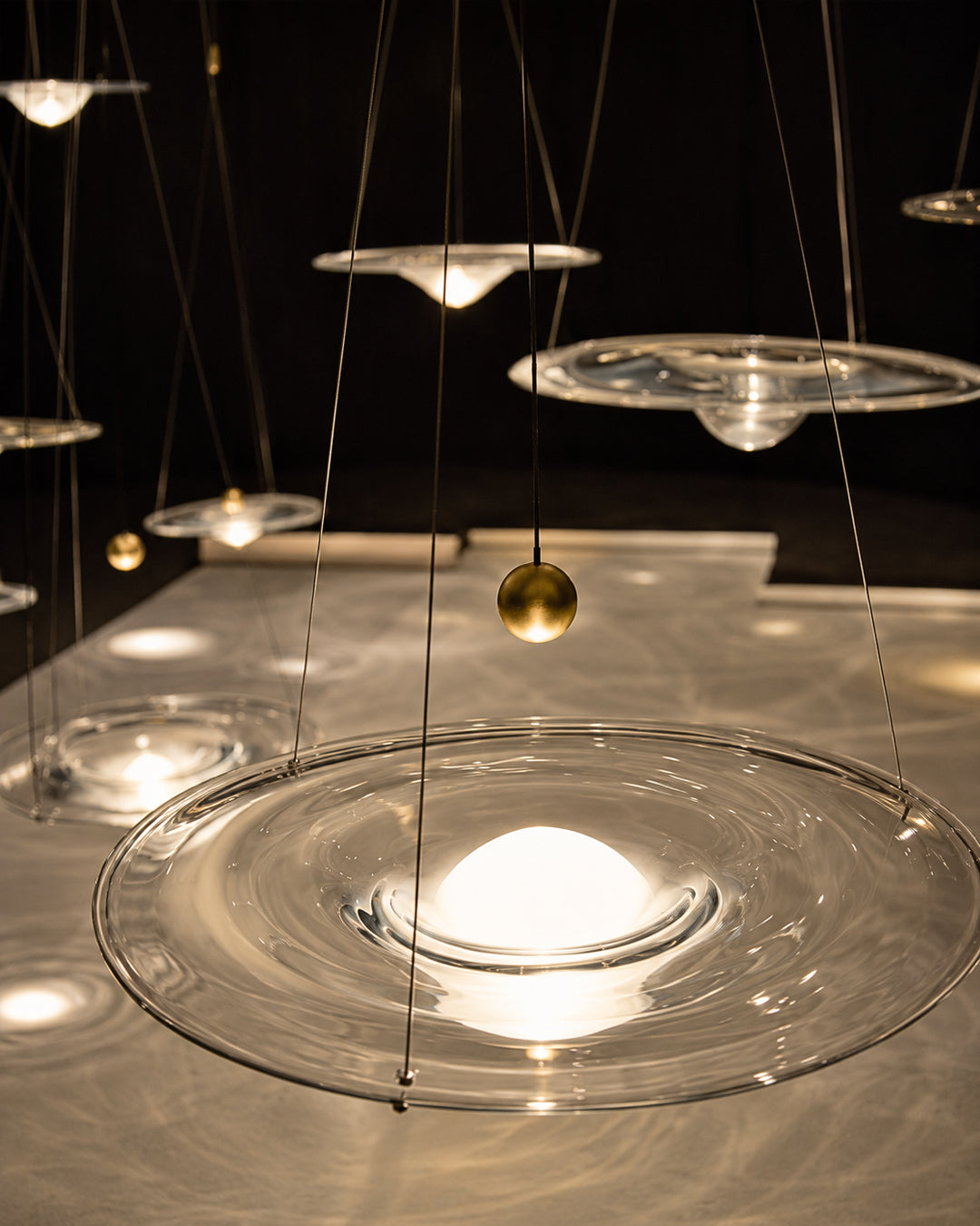 Close-up of glass disc and steel wire suspension