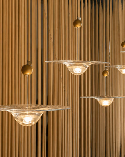 Ripple glass pendant light illuminated, showing warm glow