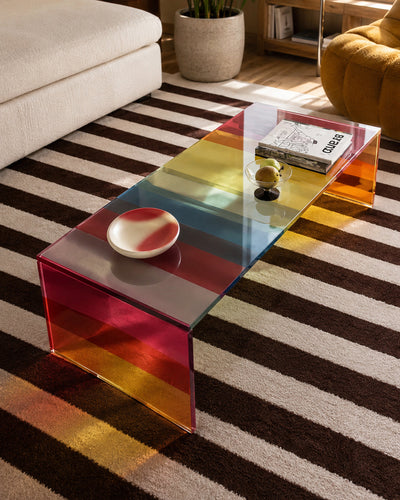 Dichroic glass table reflecting ambient light in a room