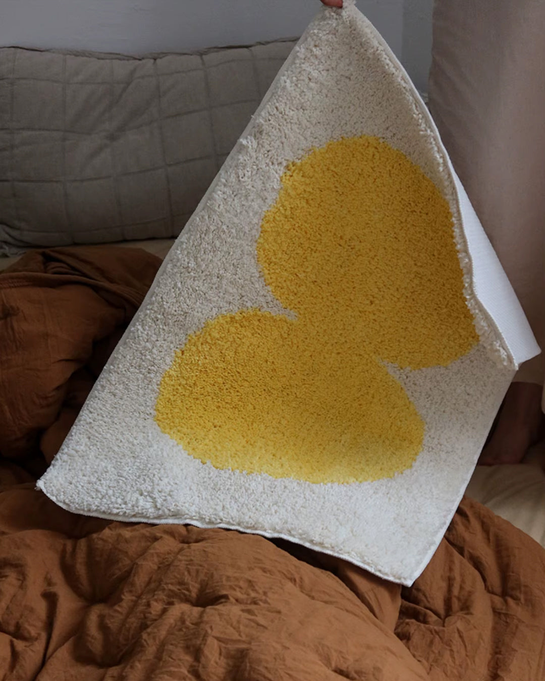 mustard accent bath mat closeup detail shot showing tufted texture