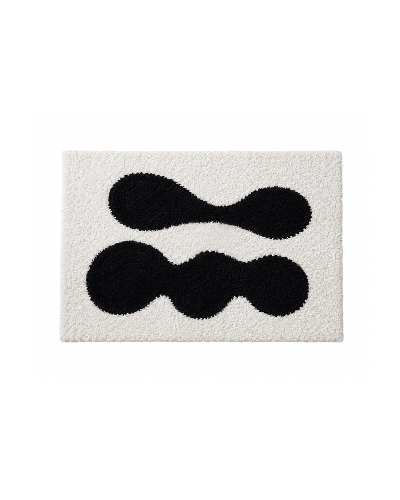 Abstract black and white tufted doormat, full top-down view