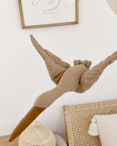 Stork mobile styled above a crib in a nursery