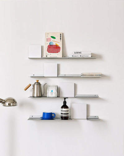 Wall shelf displaying small decor objects