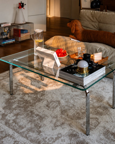 Close-up of stainless steel leg on glass coffee table