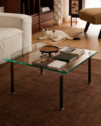 Glass coffee table paired with a sofa in a lounge setting
