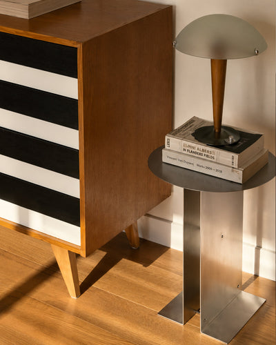 hand-polished steel table shown as a bedside surface