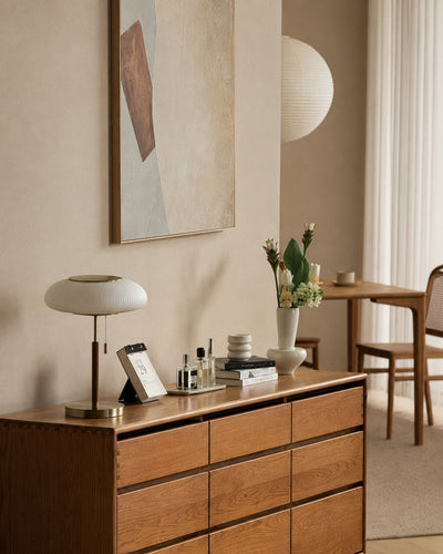 Ribbed glass table lamp illuminated, showing warm glow