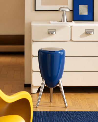 egg shape trash can shown styled in a modern living room corner