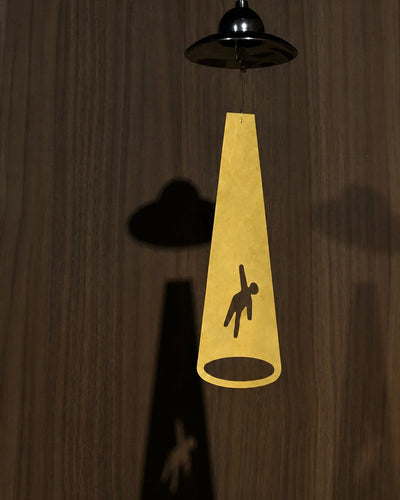 Close-up of polished metal saucer on wind chime