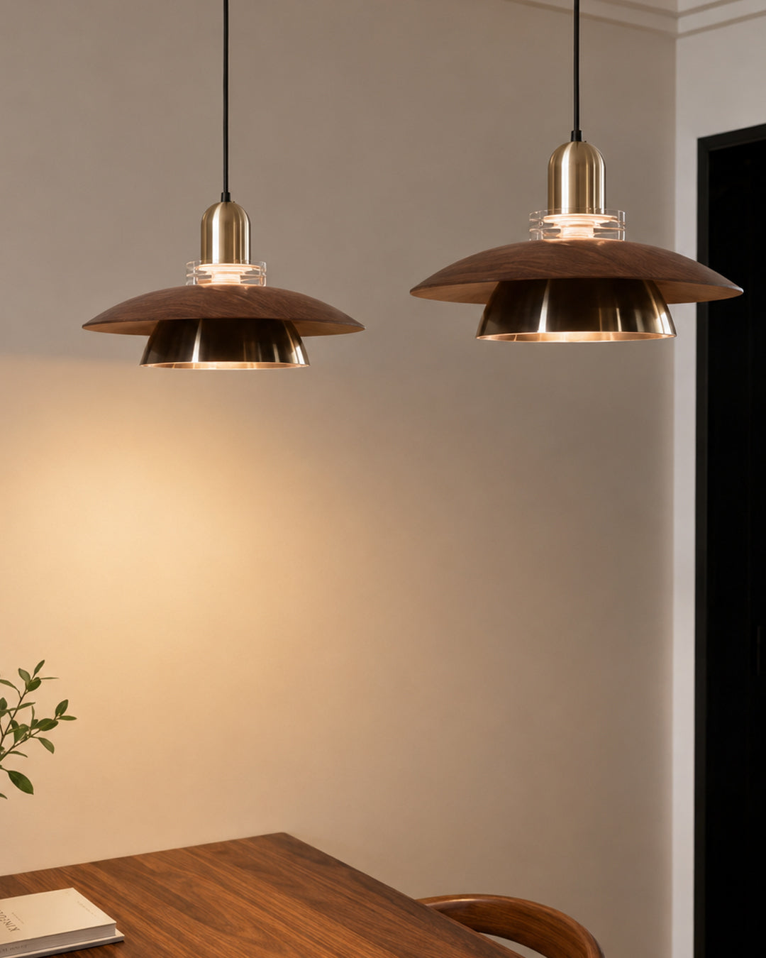 Two pendant lights hung side by side over a table