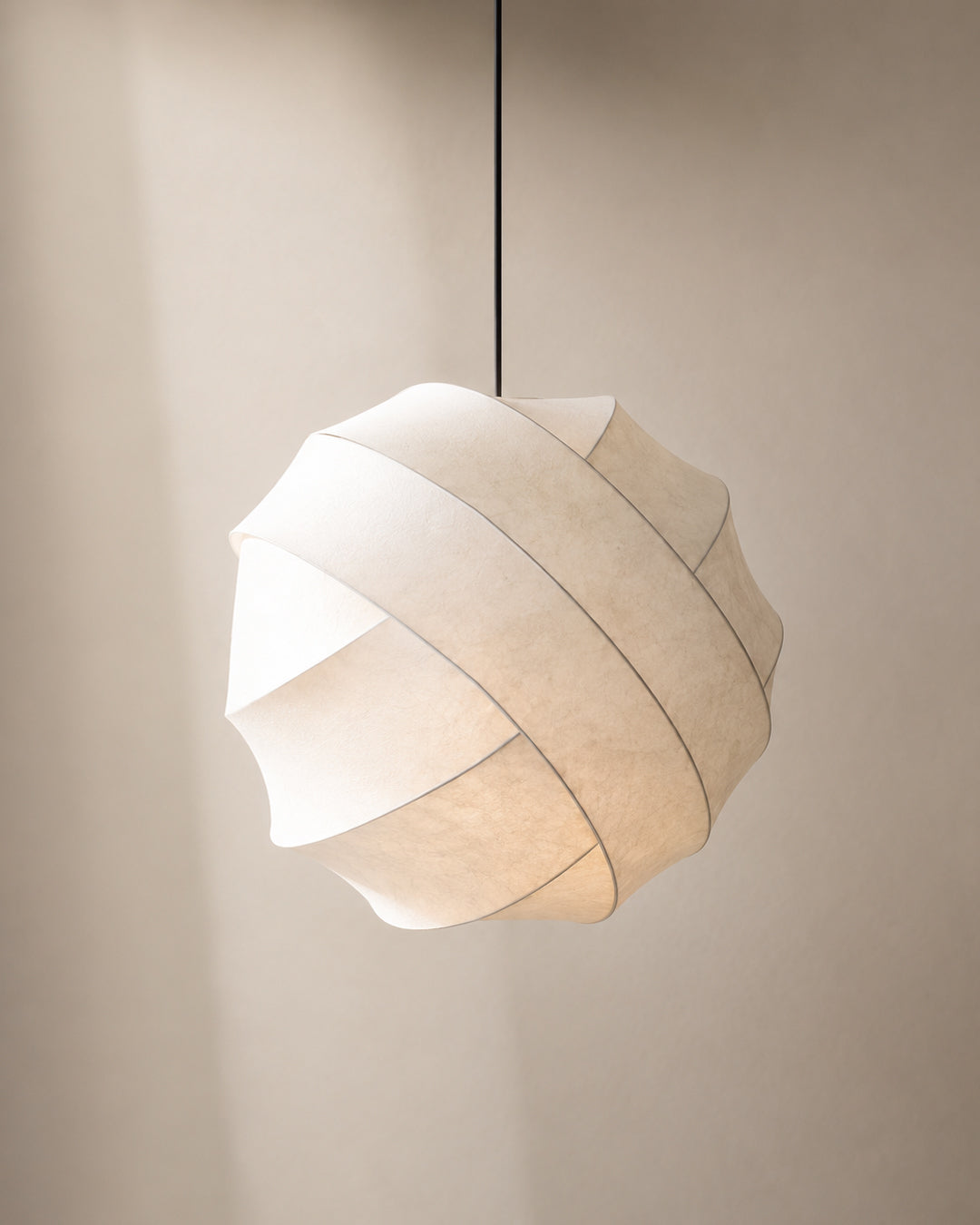 Silk pendant light illuminated, showing soft warm glow