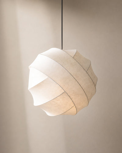 Silk pendant light illuminated, showing soft warm glow